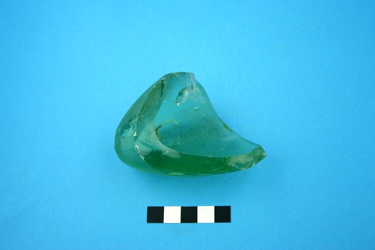 Fragment of green glass bottle base and body.