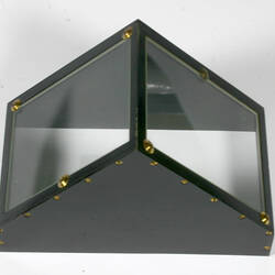 Pyramid shaped black metal instrument with glass sides.