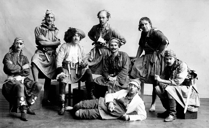 Actors dressed as pirates posing on stage.
