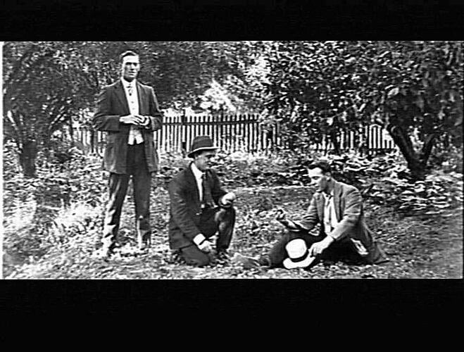 MERRIGUM - THREE MEN POSED IN GARDEN