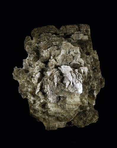 Stacked plates of brown mineral.