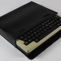 Small portable computer in black case.