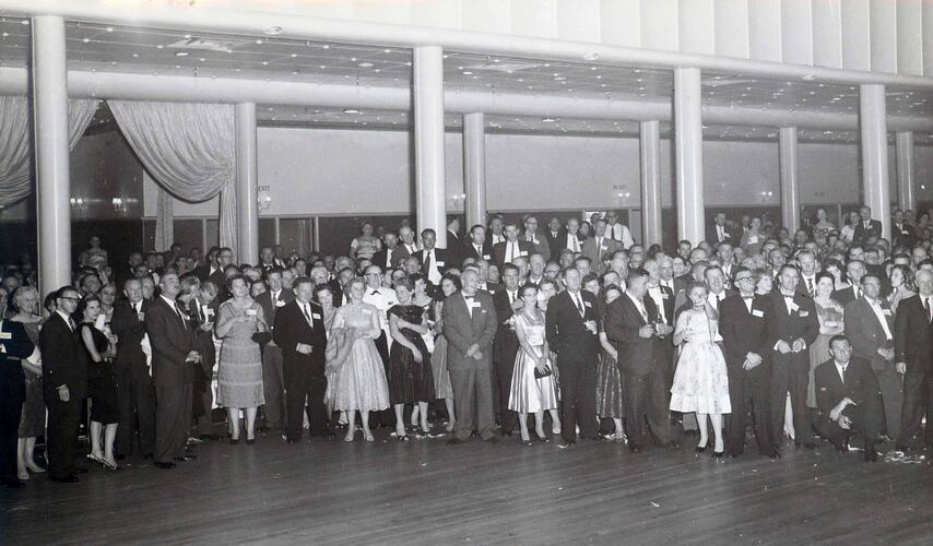 A large group of people stand in the Palais Theatre Ballroom.