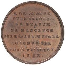 Round medal with raised text.