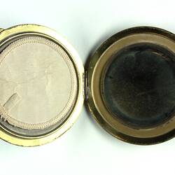 Open powder compact showing sponge and mirror.