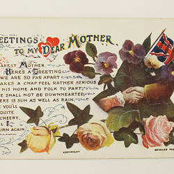 Front of postcard with coloured flowers and text.