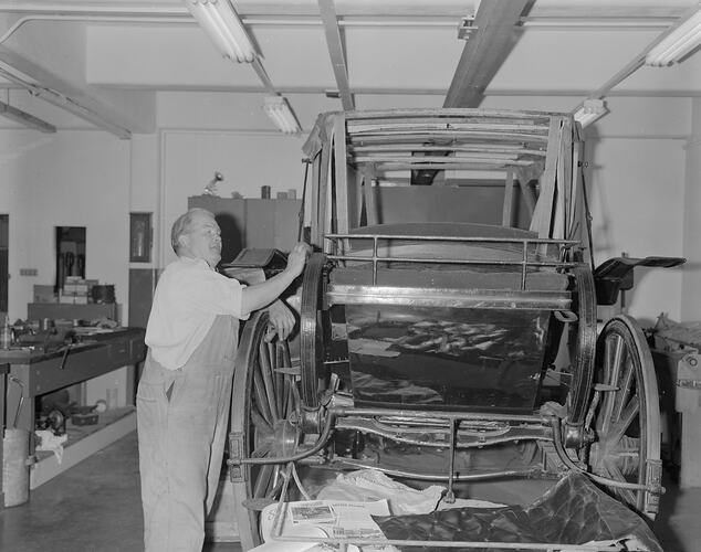 Tom Baird restoring state coach ('Square Landau') at the Science Museum, Melbourne, 1971
