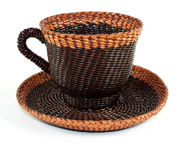Brown and tan leather braided teacup and saucer.