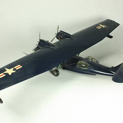 Navy twin propeller aeroplane model. White stars and red and white flags on wings.