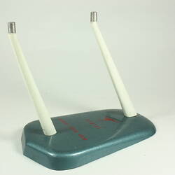 Shield shaped grey cast metal stand with two upright white metal supports. Red flying kangaroo, text on stand.