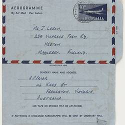 Aerogramme, blue paper, unfolded, handwritten and printed text.