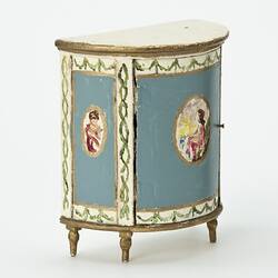 Semi-circular bedside table painted blue and cream with gold edging. Central oval portrait on front and right.