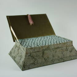 Box with open lid showing scrolls inside.