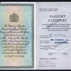 Open passport with two white pages with coloured printed pattern on left. Printed and handwritten text. Stampe