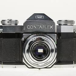 Black camera, central metal lens section and dials on top.