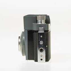 Black, grey and silver, metal and plastic 35mm camera. Left profile.