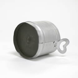 Side view of tiny aluminium pot showing underside.