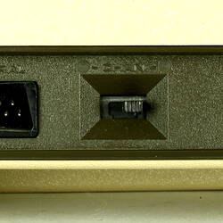Connector ports and switches of beige plastic unit.