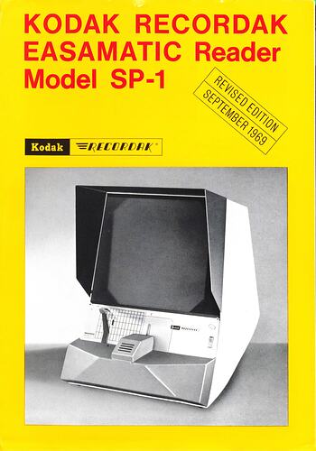 Yellow cover page with black and red text around box-shaped machine with screen.