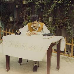 Digital Photograph - Abdul Fahour (Wafa's Father) Writing a Letter in Carlton, 1970
