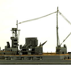 Naval ship with mast, facing left.