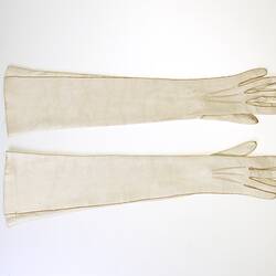 Elbow-length, cream leather gloves.