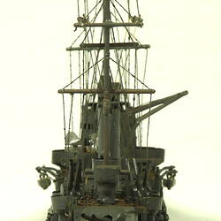 Naval ship with two masts, rear view.