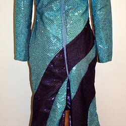 Rear view of light blue full length sequin dress with dark blue swirls from shoulder to hip.