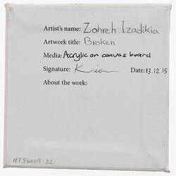 Label on back of white canvas with printed and handwritten text.