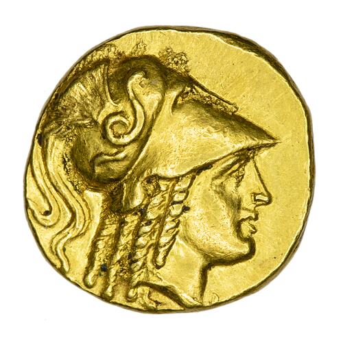 Head of Goddess Athena facing right wearing crested Corinthian helmet.