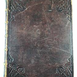 Bible with embossed brown leather cover.