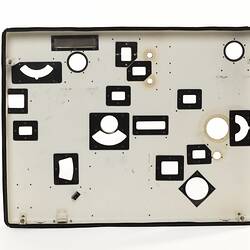 White rectanguar plate with small cut out sections framed by black.