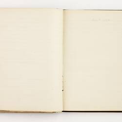 Open book with off white ruled pages.