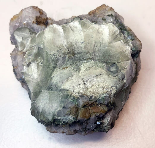 Greyish-white crystal formation.