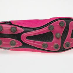 Pink Australian Rules football boot with black bootlace, inner sole and sole.