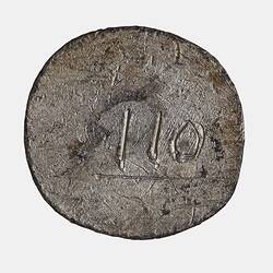 Round coin, scratched surface with some engraved markings.