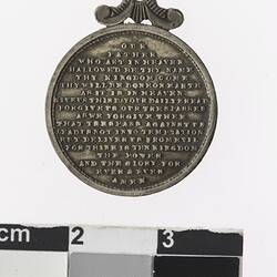 Round medal with text.