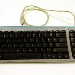 Grey computer keyboard with black keys.