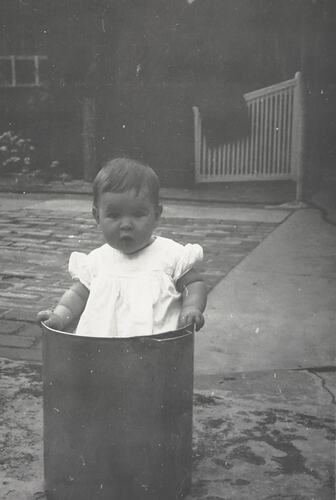Digital Photograph - Baby Standing in Nappy Bin, Backyard, Port Melbourne, circa 1964