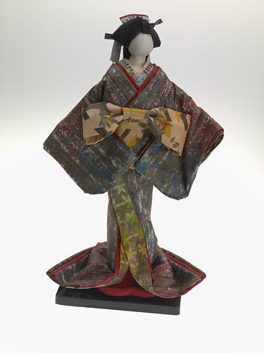 Front view of doll on mount.