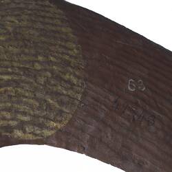 Detail of painted wooden boomerang.