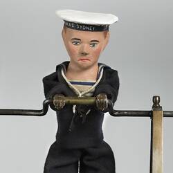 Detail of painted wooden man in sailor suit