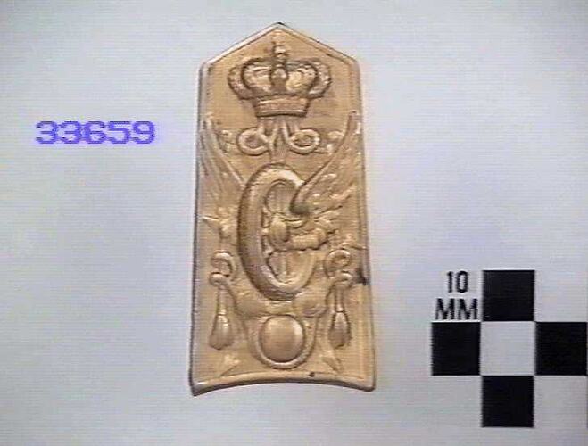 Rectangular gilt brass board, embossed design of crown/winged wheel with pneumatic tyre & tasselled cords.