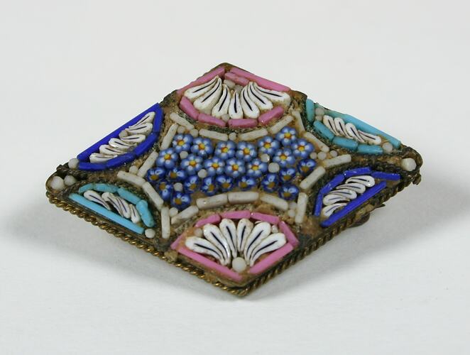 Diamond shaped broach with blue, pink and white beads.