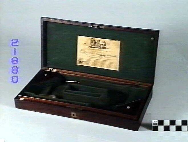 Wooden case for pistols with label.