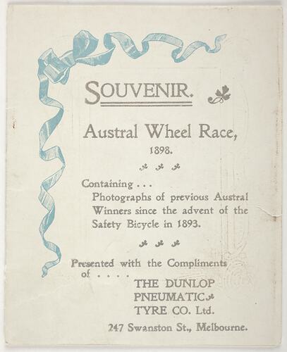 Printed souvenir pamphlet with an aqua ribbon.
