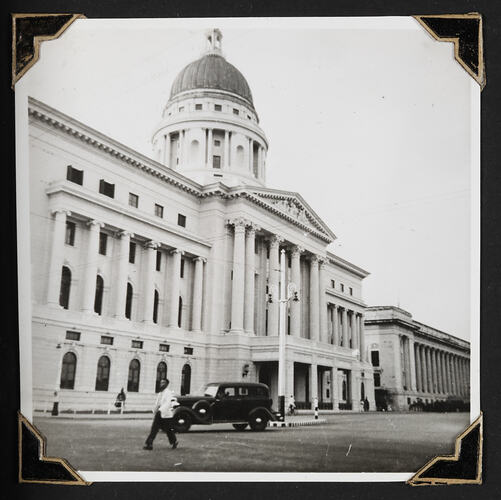 Large building with dome and colonnades in front.