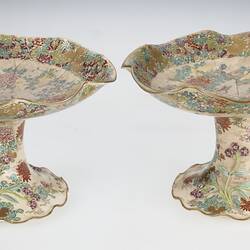 Pair of cream coloured compote with wavy edges decorated with birds & chrysanthemums.