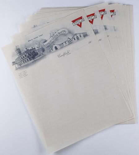 Lined paper sheets with printed illustration of three buildings, YMCA logo on letterhead.
