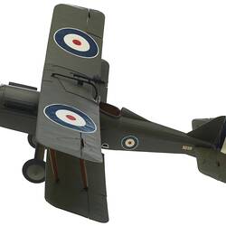 Green model airplane. Circle on top of each wing. Left profile.
